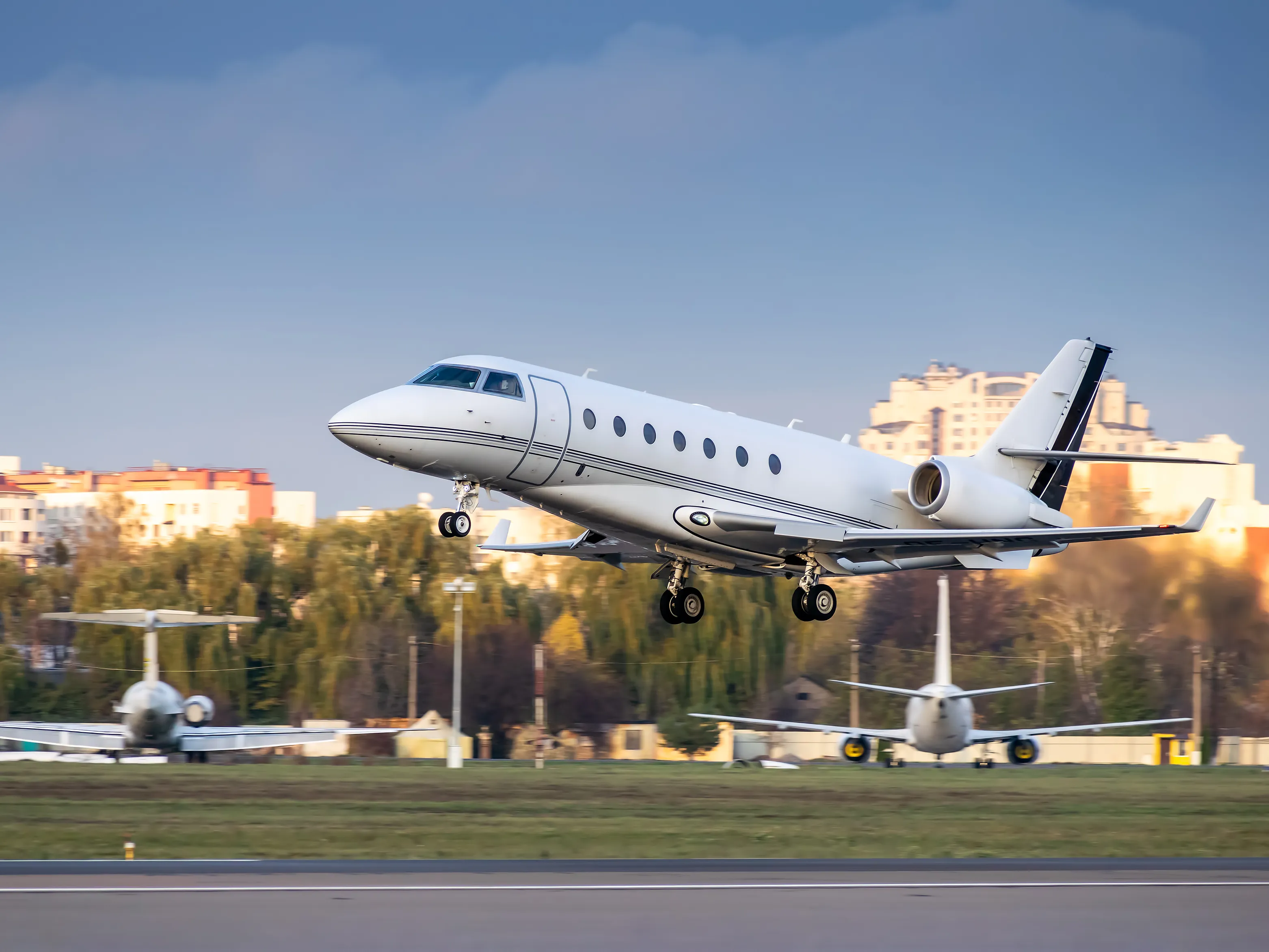 A business jet taking off, side view