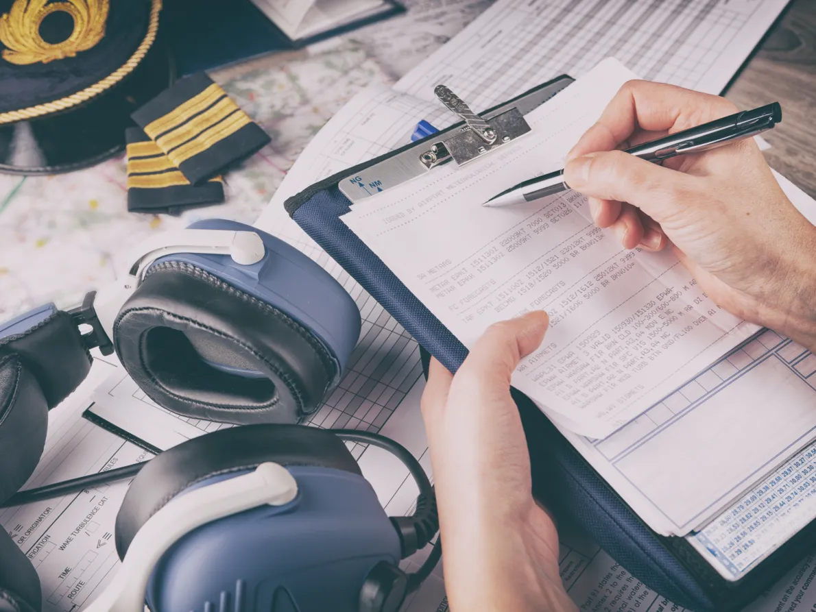 A pilot filling out an airport analysis